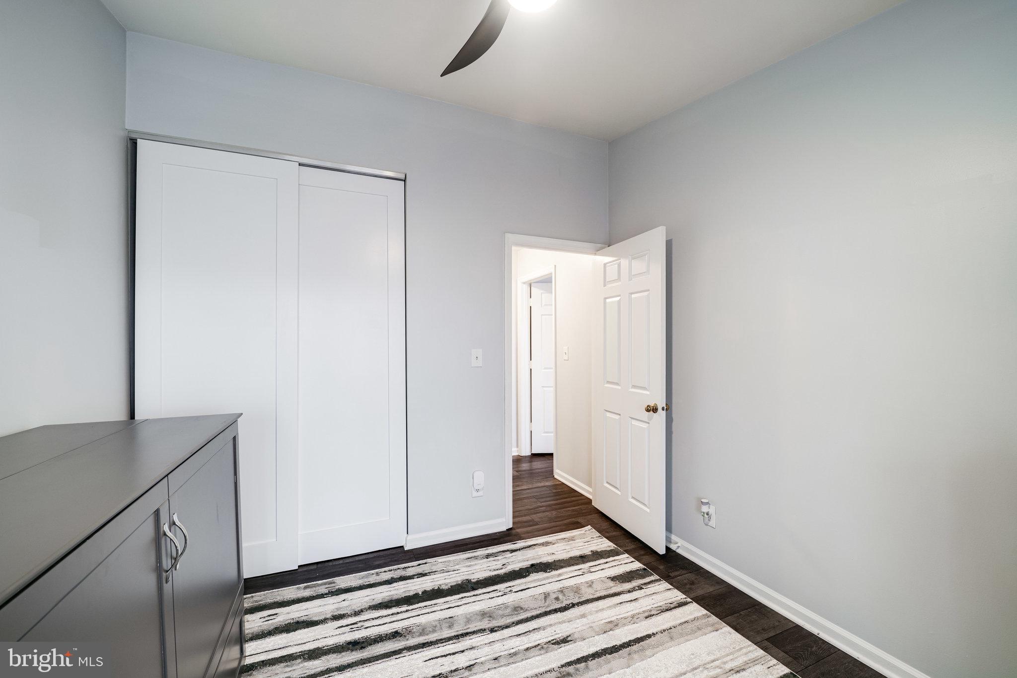 7510 Ashby Lane, Unit J Alexandria, VA 22315 - Photo 29 of 53 a view of a room with wooden floor and cabinet