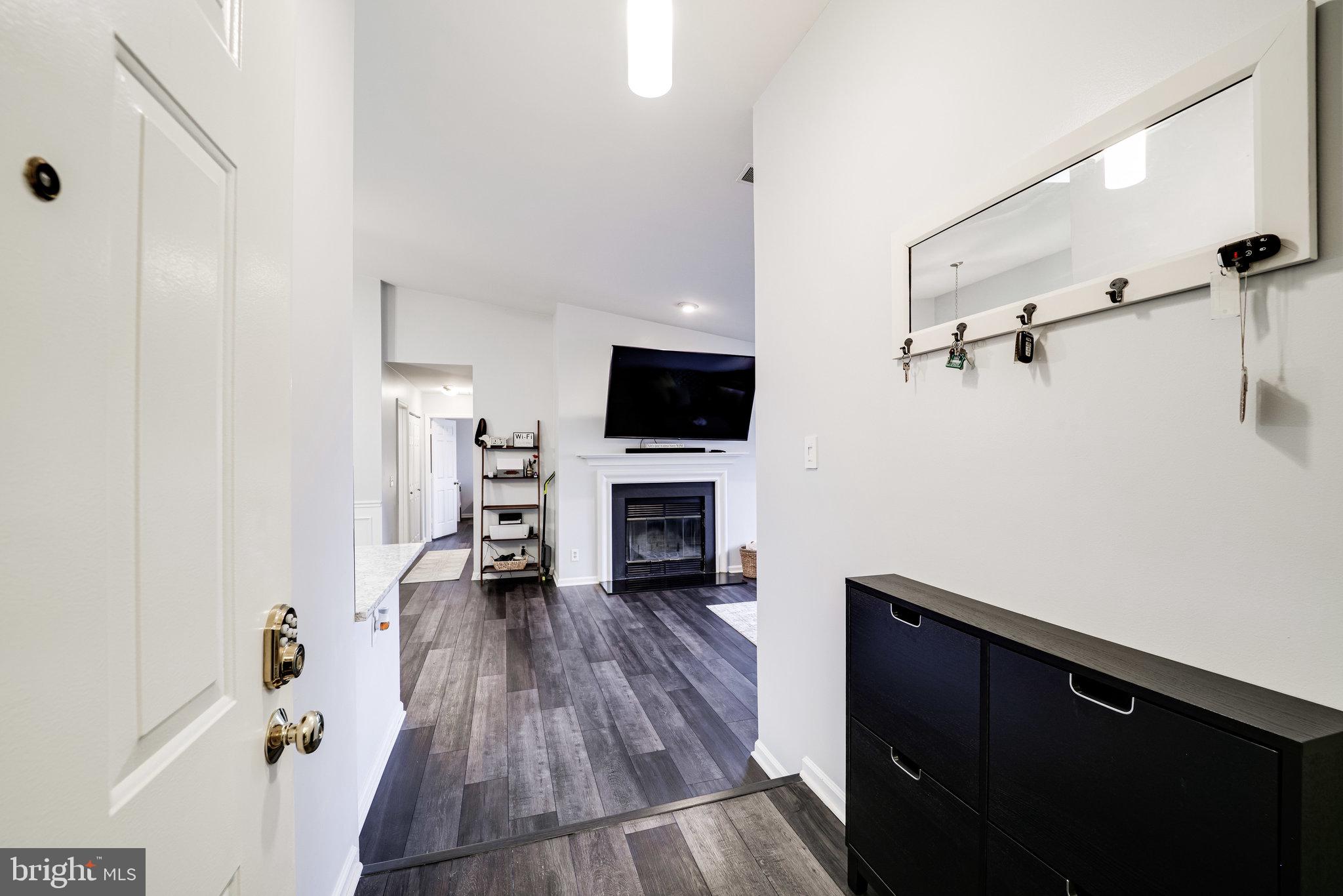 7510 Ashby Lane, Unit J Alexandria, VA 22315 - Photo 4 of 53 a view of a livingroom with wooden floor and a fireplace