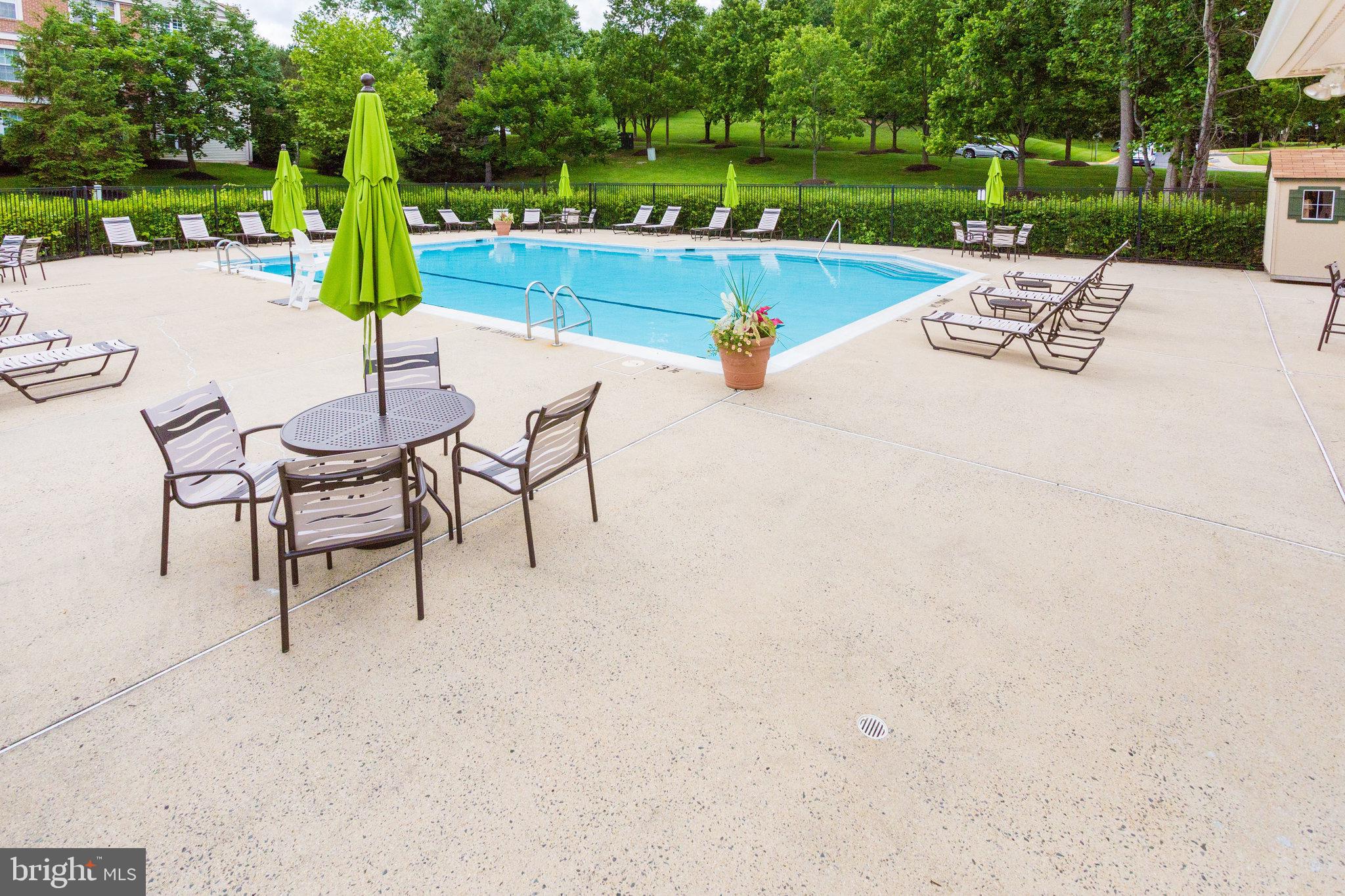 7510 Ashby Lane, Unit J Alexandria, VA 22315 - Photo 40 of 53 a view of a patio with a table and chairs