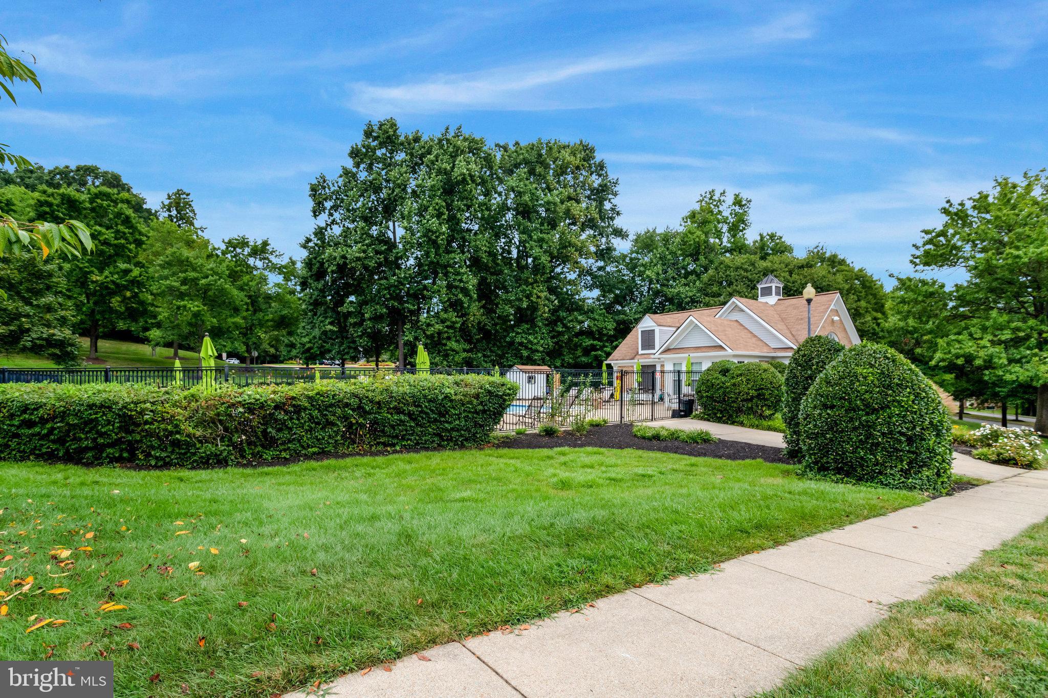7510 Ashby Lane, Unit J Alexandria, VA 22315 - Photo 52 of 53 a view of a garden with a building in the background