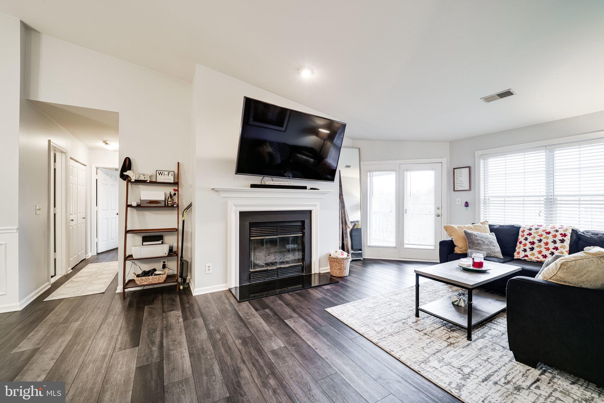 7510 Ashby Lane, Unit J Alexandria, VA 22315 - Photo 6 of 53 a living room with furniture and a fireplace