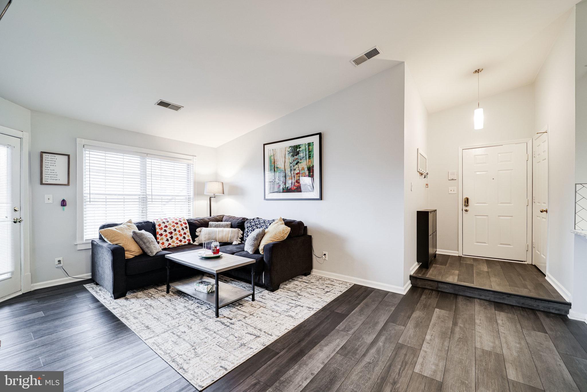 7510 Ashby Lane, Unit J Alexandria, VA 22315 - Photo 7 of 53 a living room with furniture and wooden floor