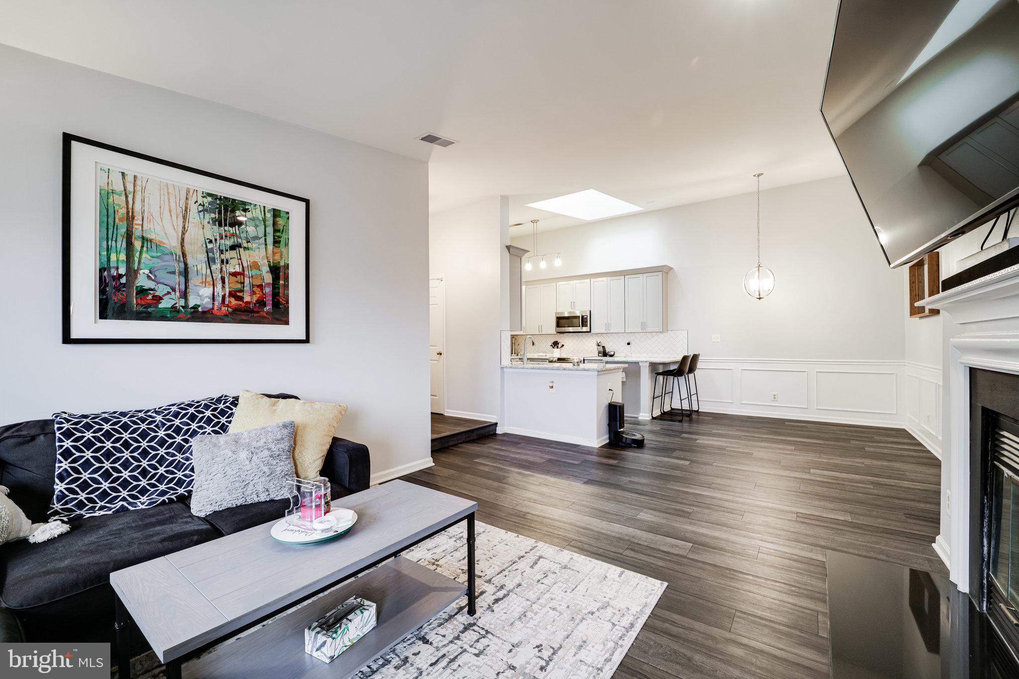 7510 Ashby Lane, Unit J Alexandria, VA 22315 - Photo 8 of 53 a living room with furniture and a fireplace