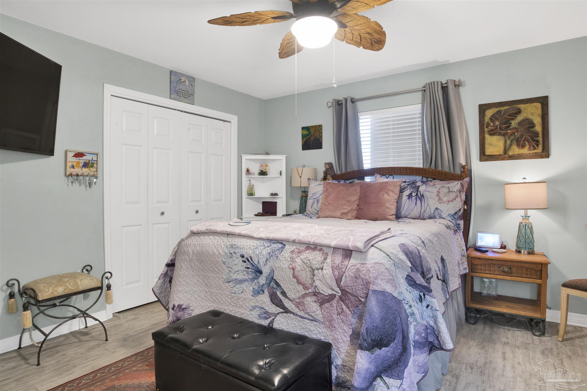 13351 Johnson Beach Road, Unit 203E Perdido Key, FL 32507 - Photo 16 of 55 a bedroom with a bed and a chandelier