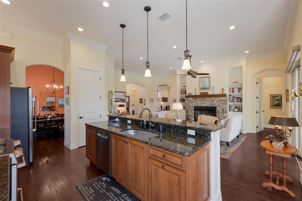 5011 Tobermory Way Bradenton, FL 34211 - Photo 14 of 77 a large kitchen with kitchen island a large island in the center and stainless steel appliances