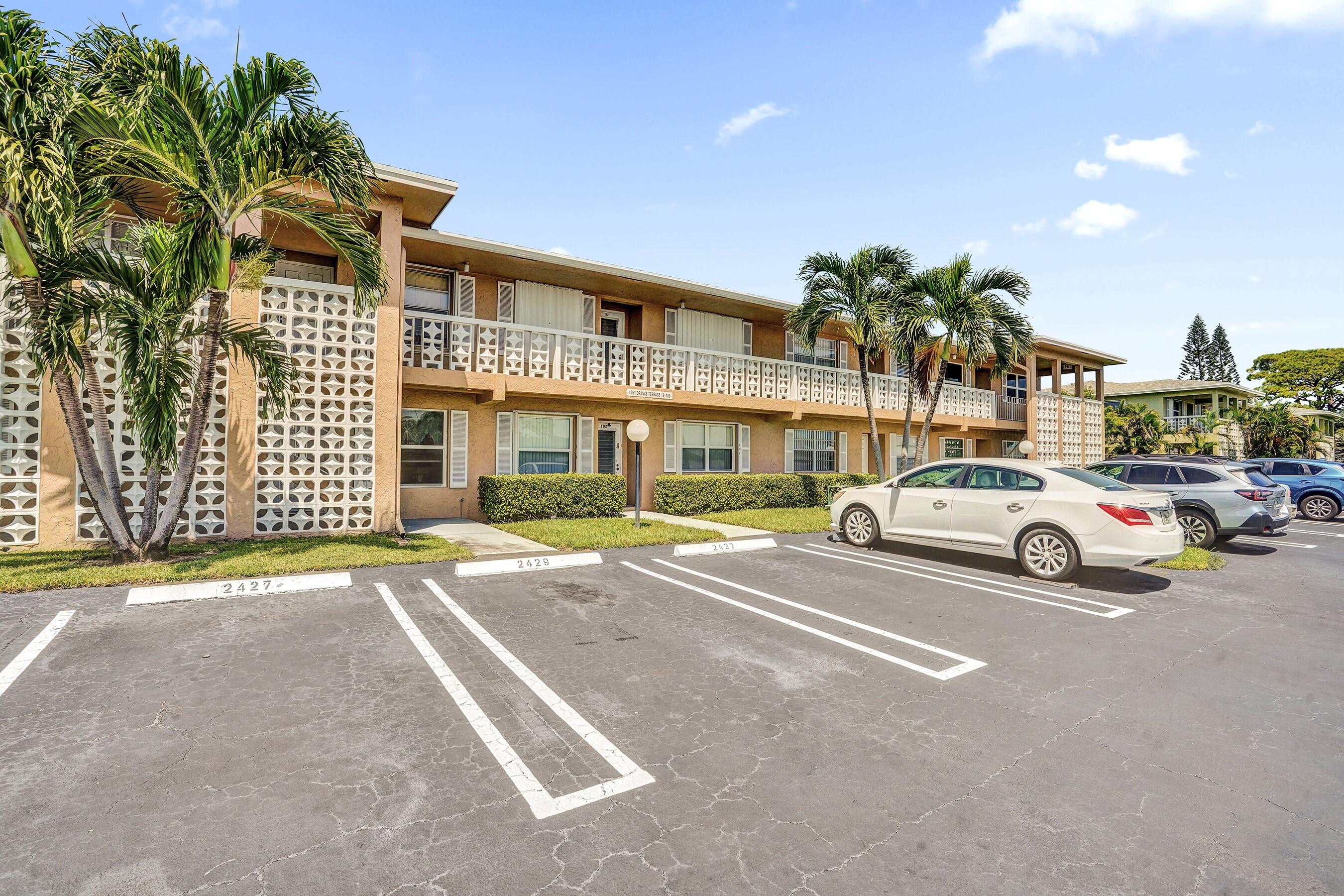 1051 Orange Terrace, Unit 101 Delray Beach, FL 33445 - Photo 20 of 54 a view of a cars park in front of a building