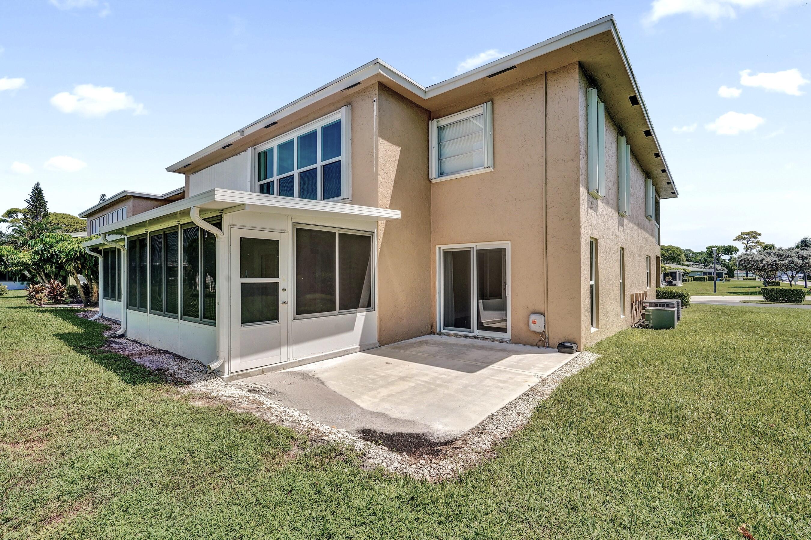 1051 Orange Terrace, Unit 101 Delray Beach, FL 33445 - Photo 21 of 54 a view of house with yard and sitting area