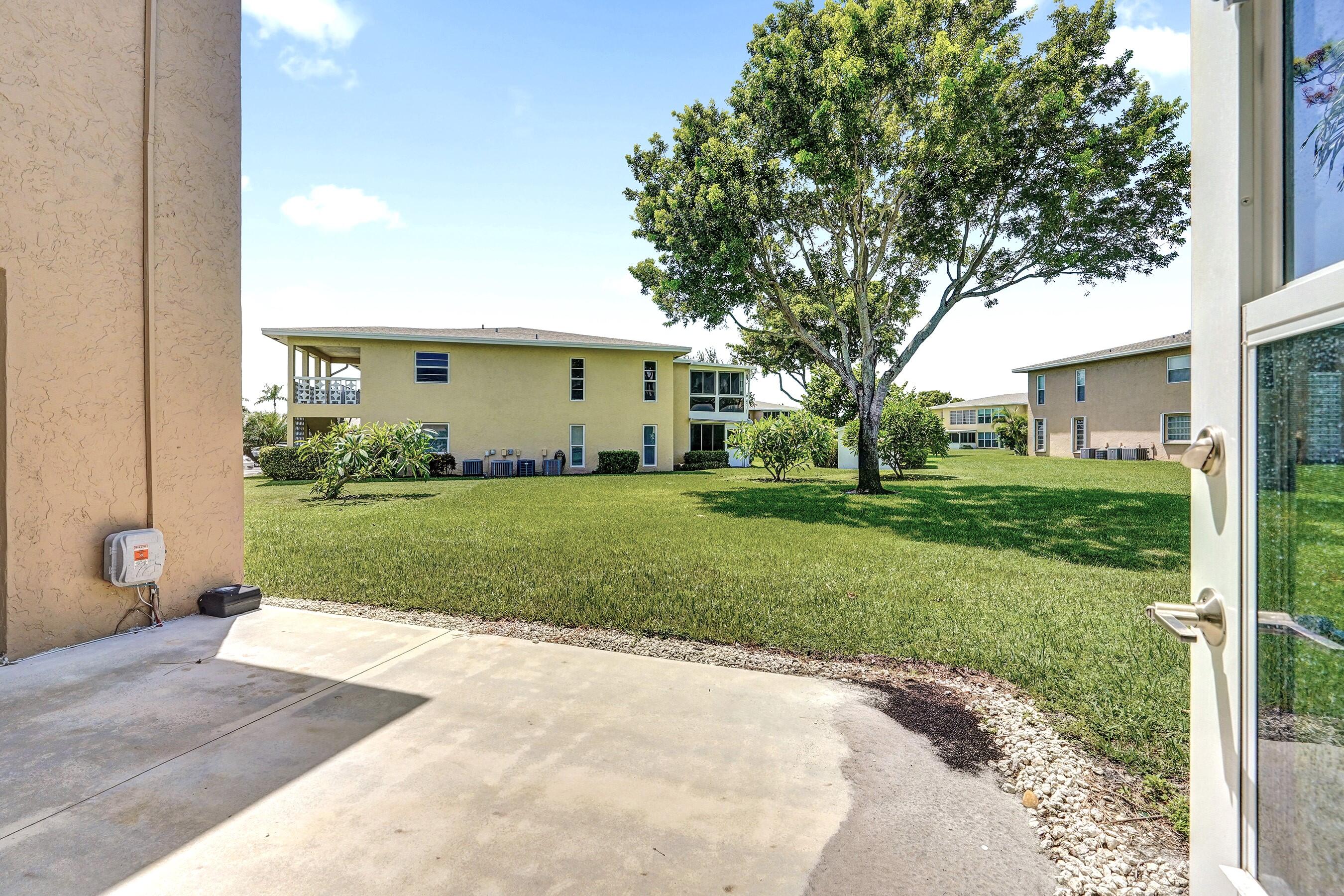 1051 Orange Terrace, Unit 101 Delray Beach, FL 33445 - Photo 25 of 54 a view of a house with a yard