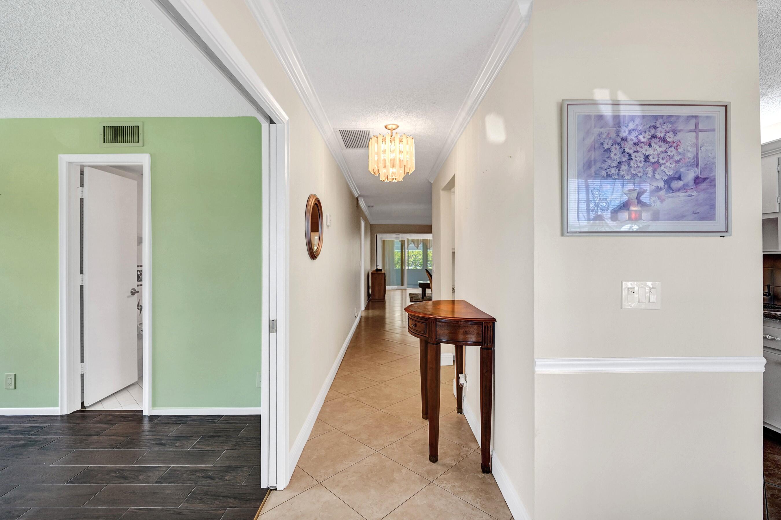 1051 Orange Terrace, Unit 101 Delray Beach, FL 33445 - Photo 28 of 54 a view of a hallway with interior of the house