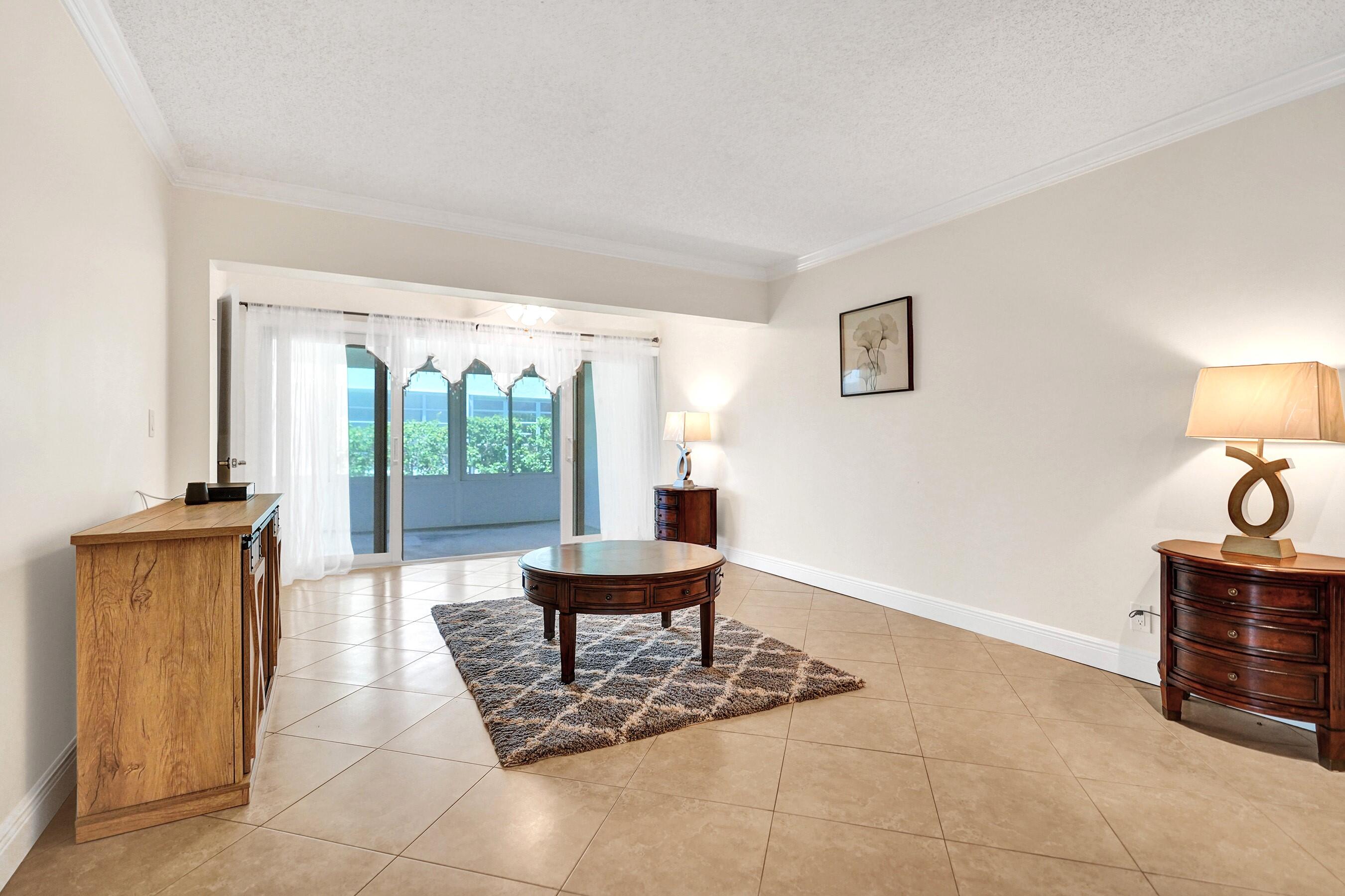1051 Orange Terrace, Unit 101 Delray Beach, FL 33445 - Photo 30 of 54 a living room with furniture and a window