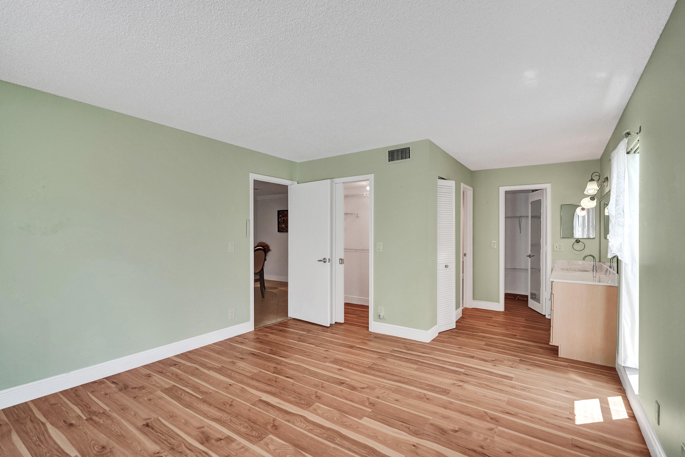 1051 Orange Terrace, Unit 101 Delray Beach, FL 33445 - Photo 34 of 54 a view of a livingroom with wooden floor and closet