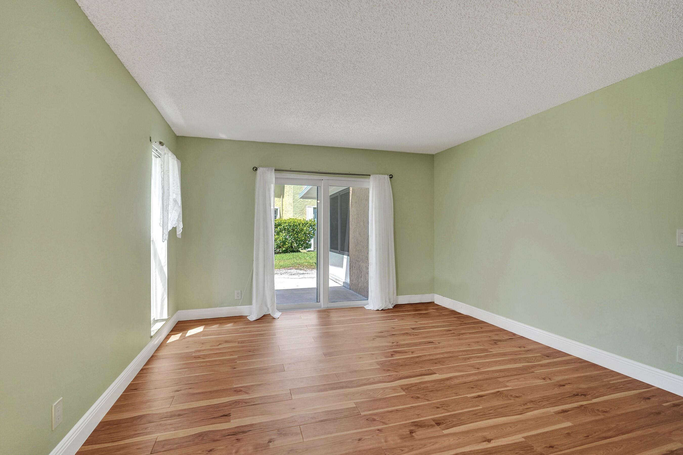 1051 Orange Terrace, Unit 101 Delray Beach, FL 33445 - Photo 35 of 54 a view of an empty room with wooden floor