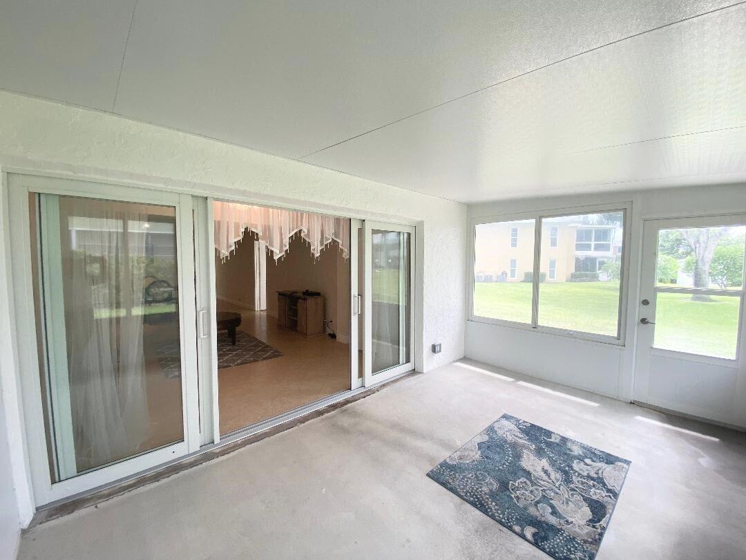 1051 Orange Terrace, Unit 101 Delray Beach, FL 33445 - Photo 38 of 54 a view of a big room with windows and cabinet