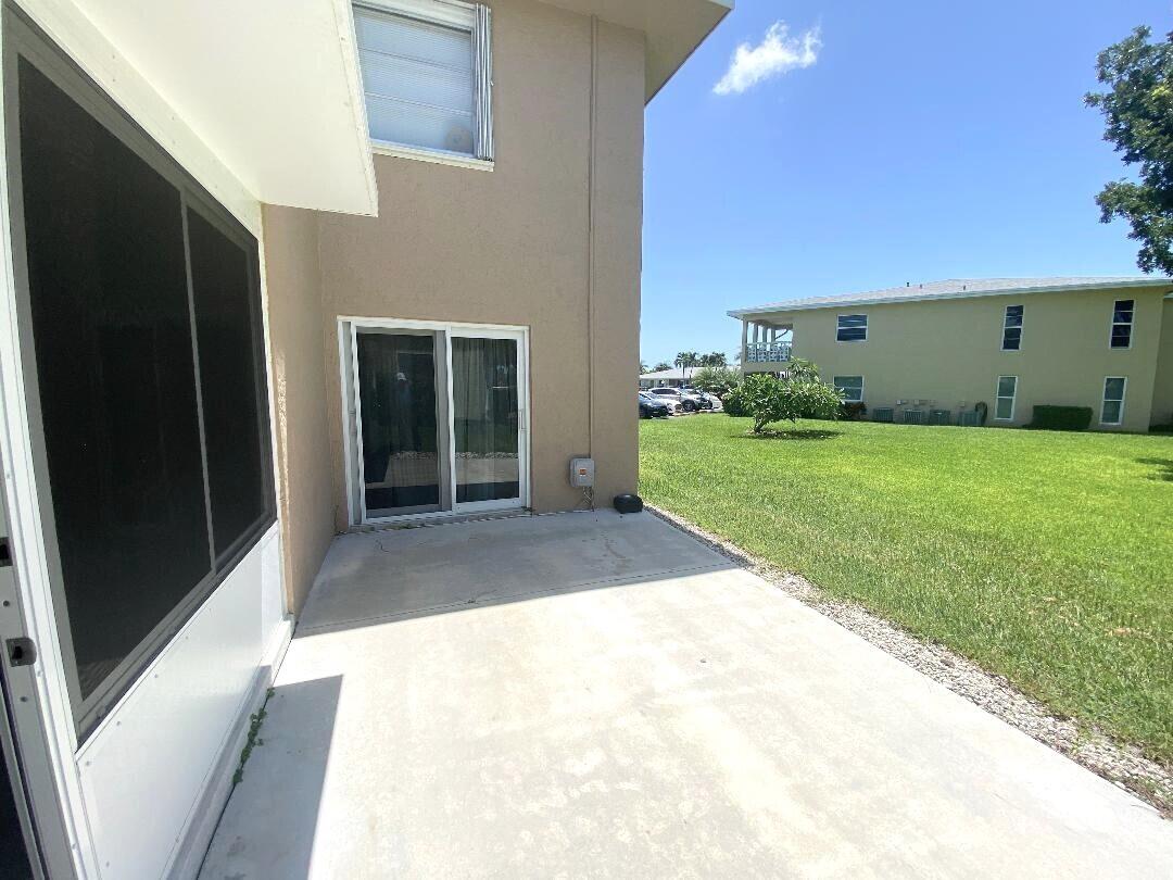 1051 Orange Terrace, Unit 101 Delray Beach, FL 33445 - Photo 39 of 54 a view of a back yard with a house