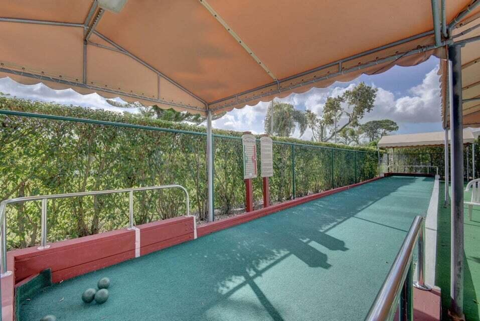 1051 Orange Terrace, Unit 101 Delray Beach, FL 33445 - Photo 48 of 54 a view of a yard from a balcony