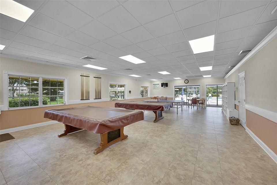 1051 Orange Terrace, Unit 101 Delray Beach, FL 33445 - Photo 52 of 54 a living room with furniture pool table and a large window