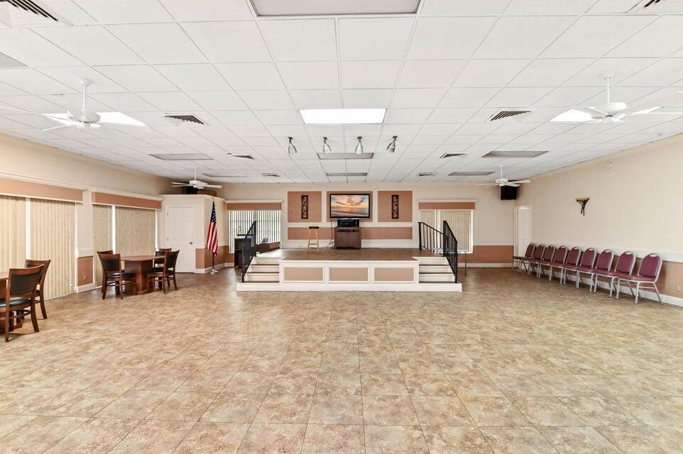 1051 Orange Terrace, Unit 101 Delray Beach, FL 33445 - Photo 53 of 54 a living room with lots of furniture and a chandelier
