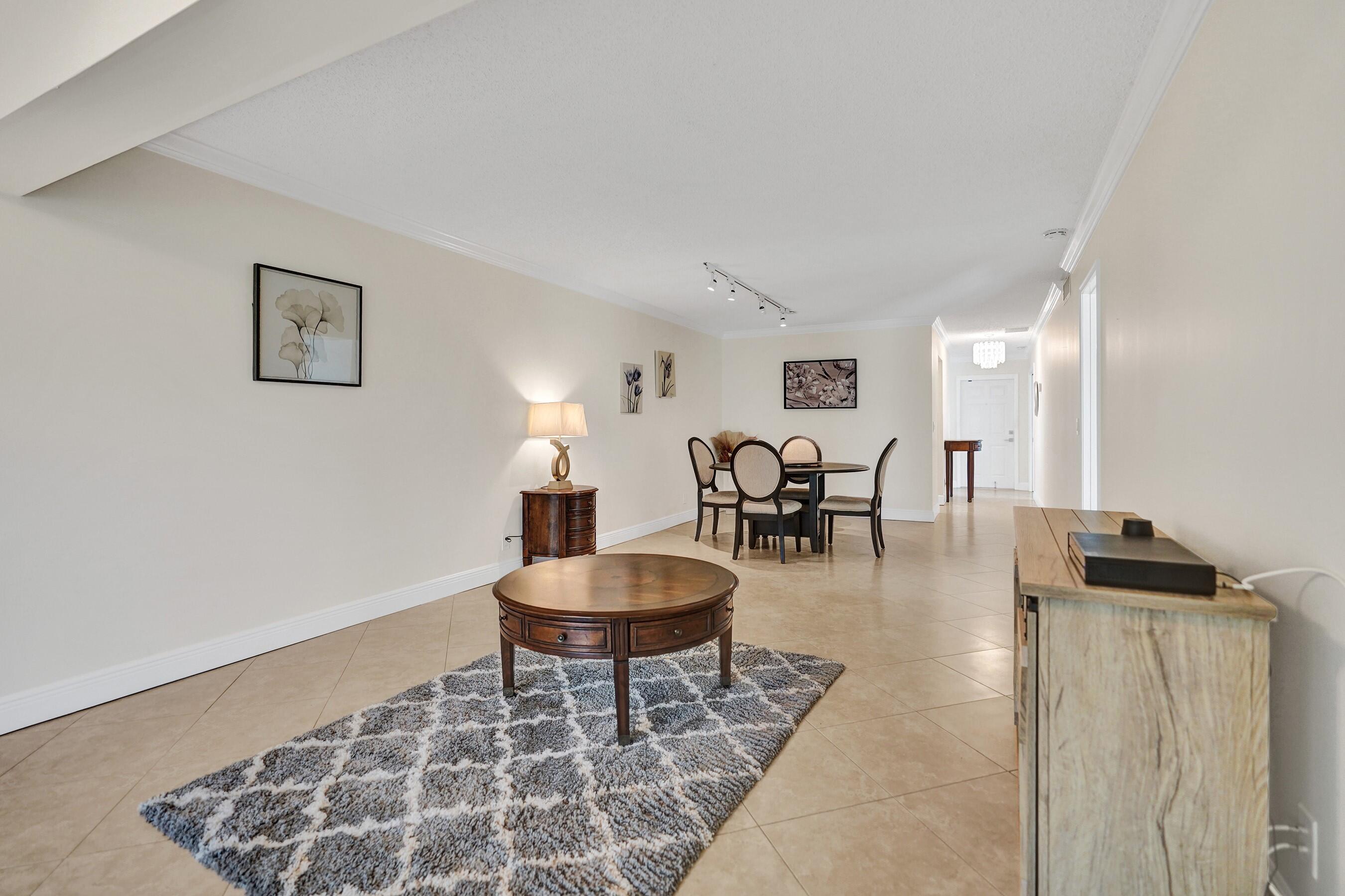 1051 Orange Terrace, Unit 101 Delray Beach, FL 33445 - Photo 6 of 54 a living room with furniture and wooden floor