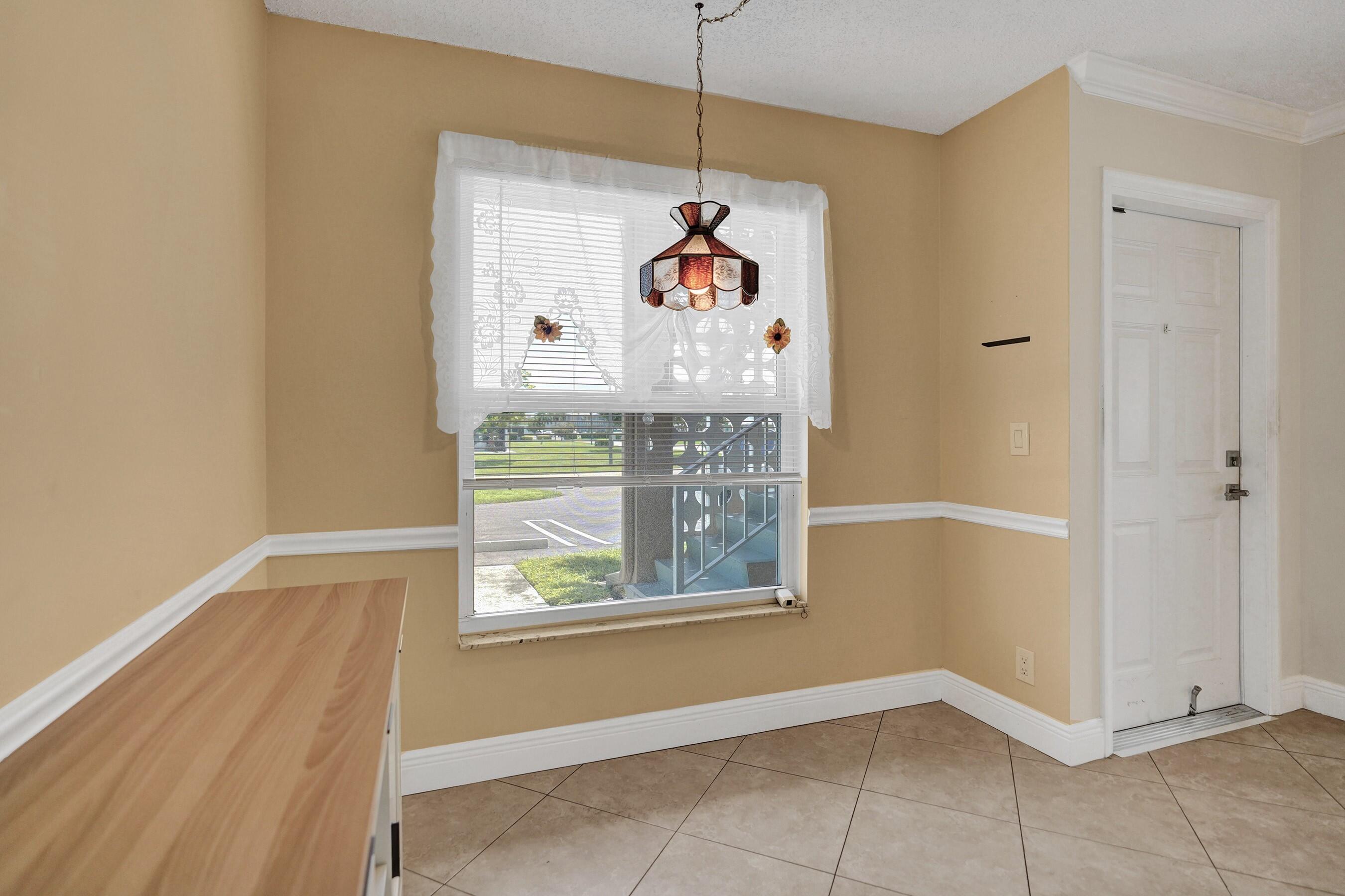1051 Orange Terrace, Unit 101 Delray Beach, FL 33445 - Photo 10 of 54 a window with ceiling fan
