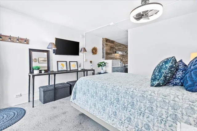 a bedroom with a bed and a flat screen tv