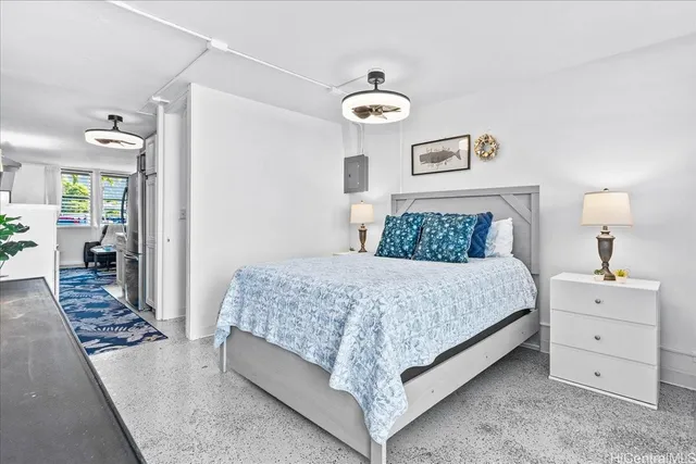 a bedroom with a bed and a chandelier