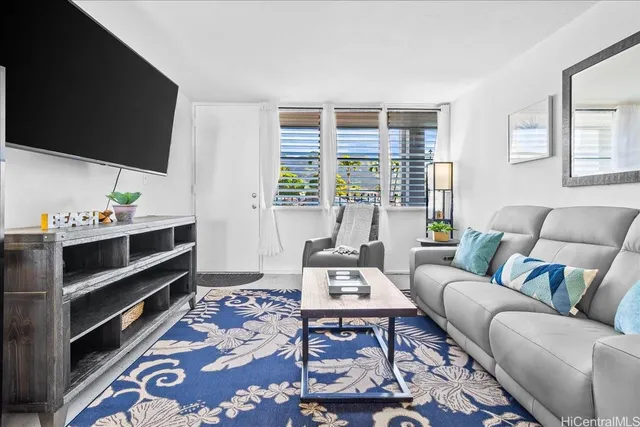 a living room with furniture and flat screen tv
