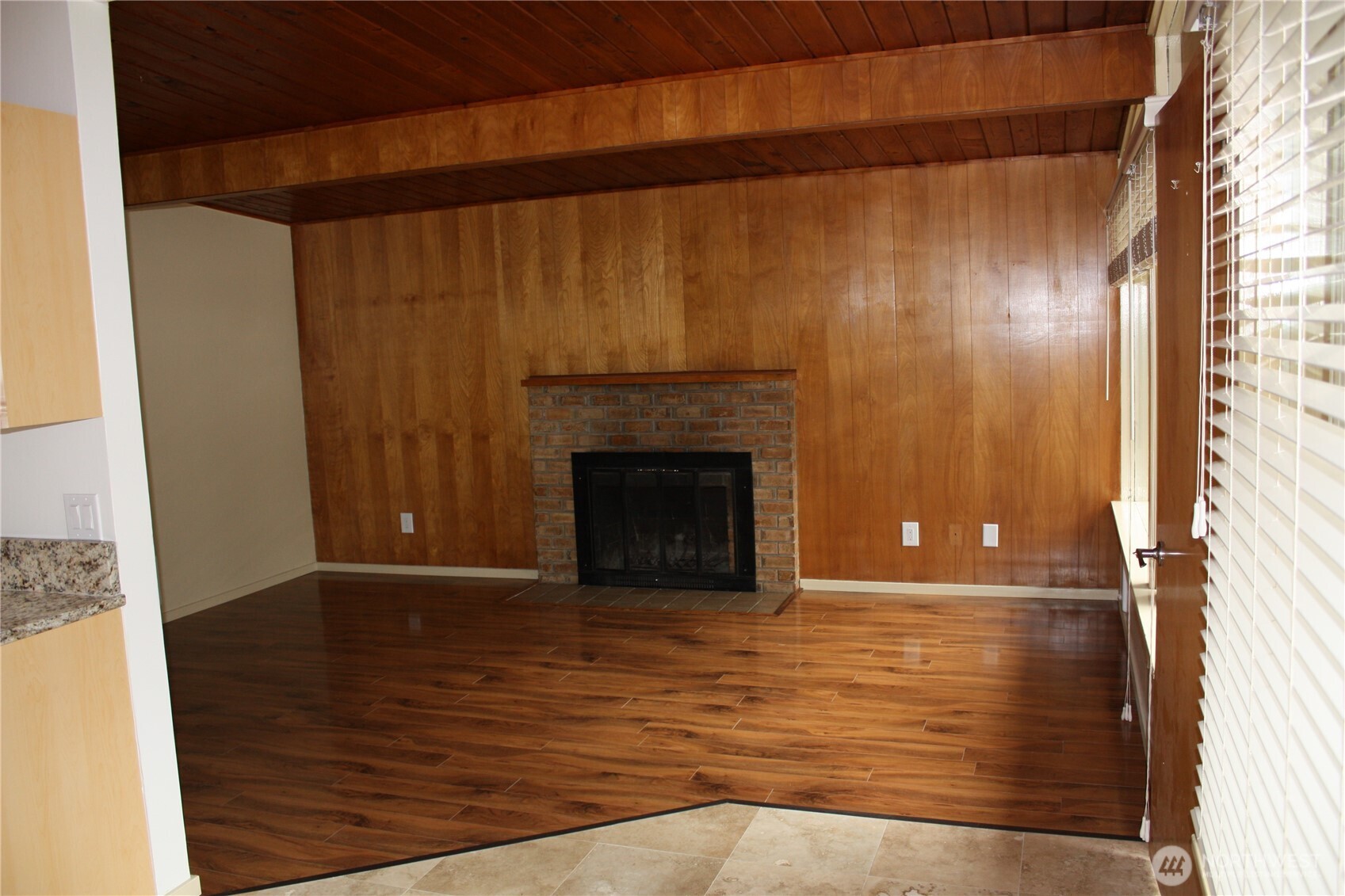 8417 Gold Way Everett, WA 98208 - Photo 11 of 18 a view of a livingroom with wooden floor and a fireplace