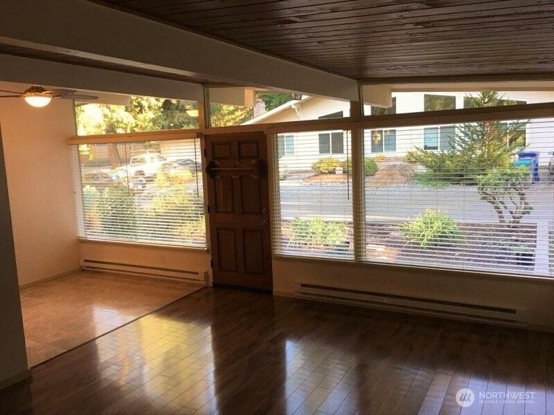 8417 Gold Way Everett, WA 98208 - Photo 12 of 18 a view of empty room with wooden floor and fan