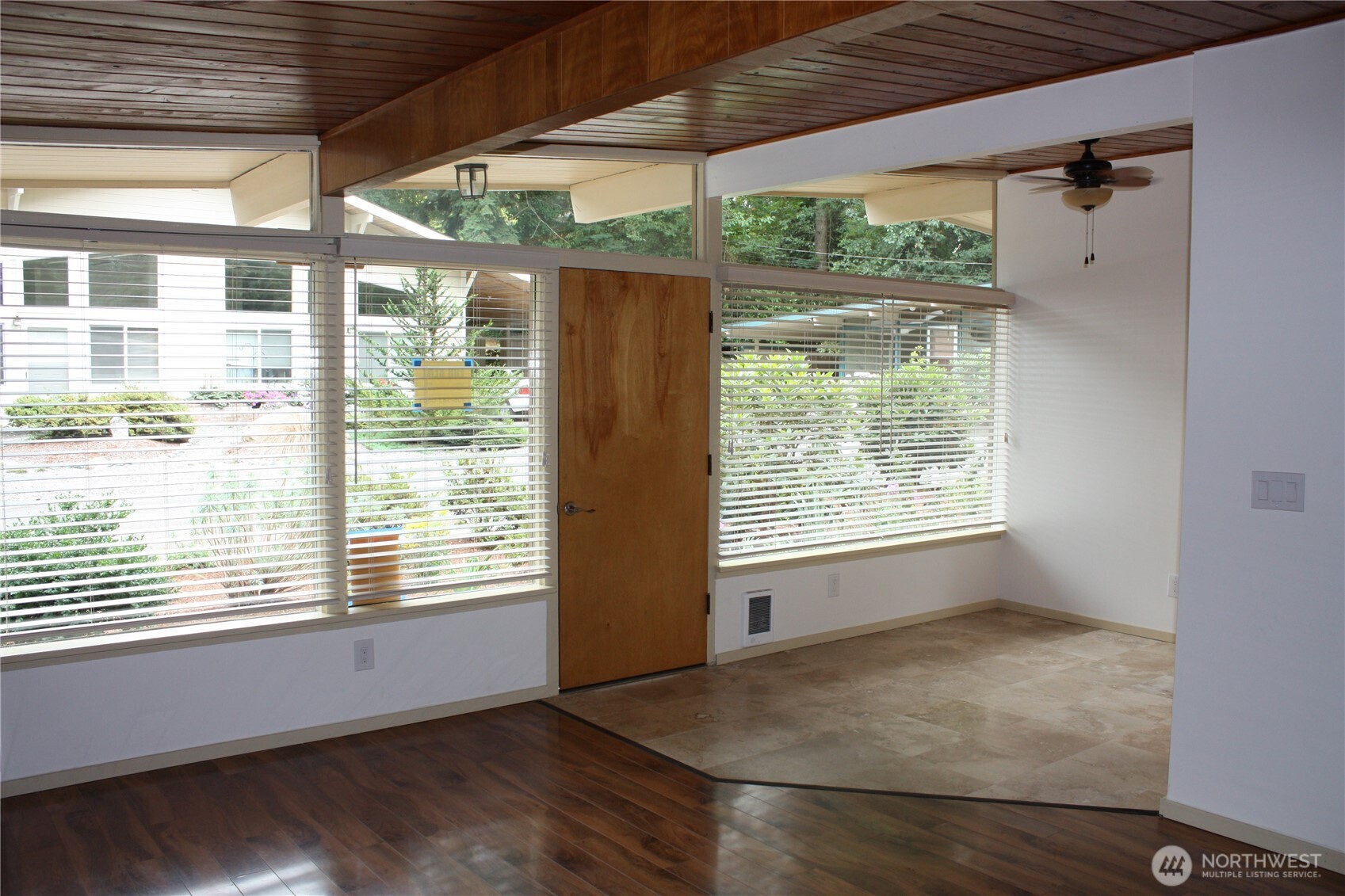 8417 Gold Way Everett, WA 98208 - Photo 4 of 18 a view of an empty room with wooden floor and a window