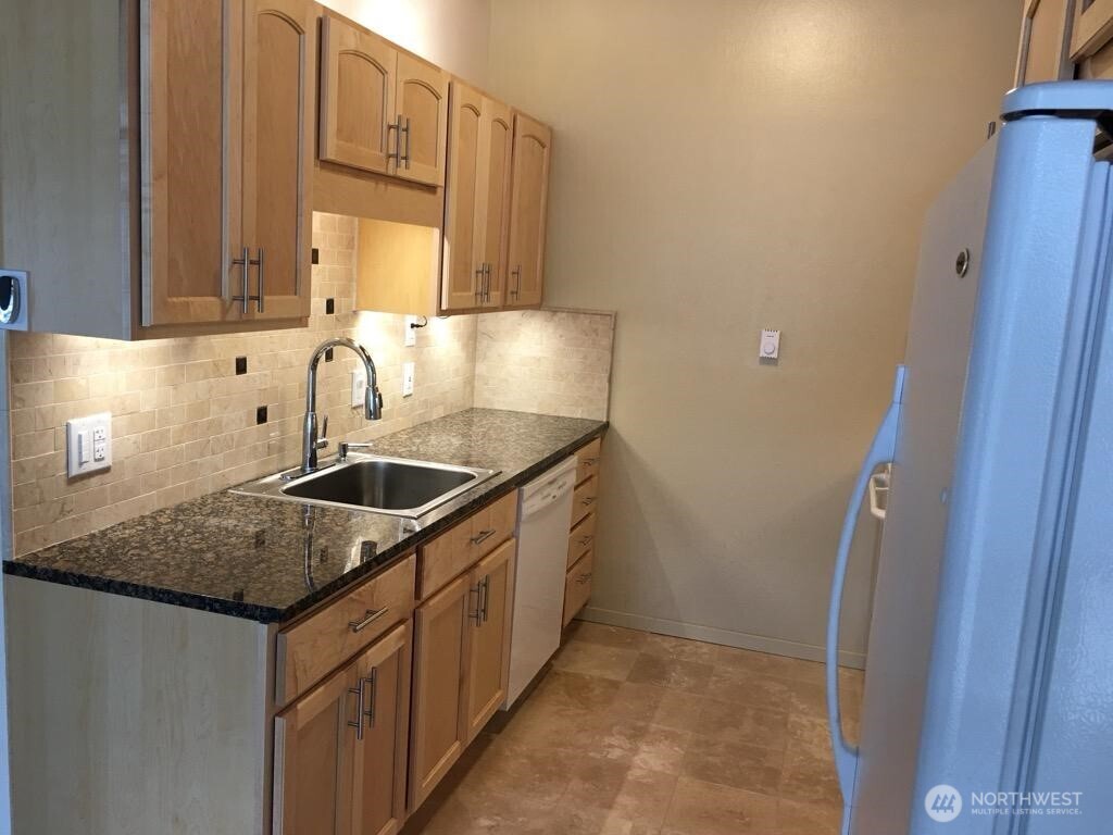 8417 Gold Way Everett, WA 98208 - Photo 5 of 18 a kitchen with a sink stove and cabinets