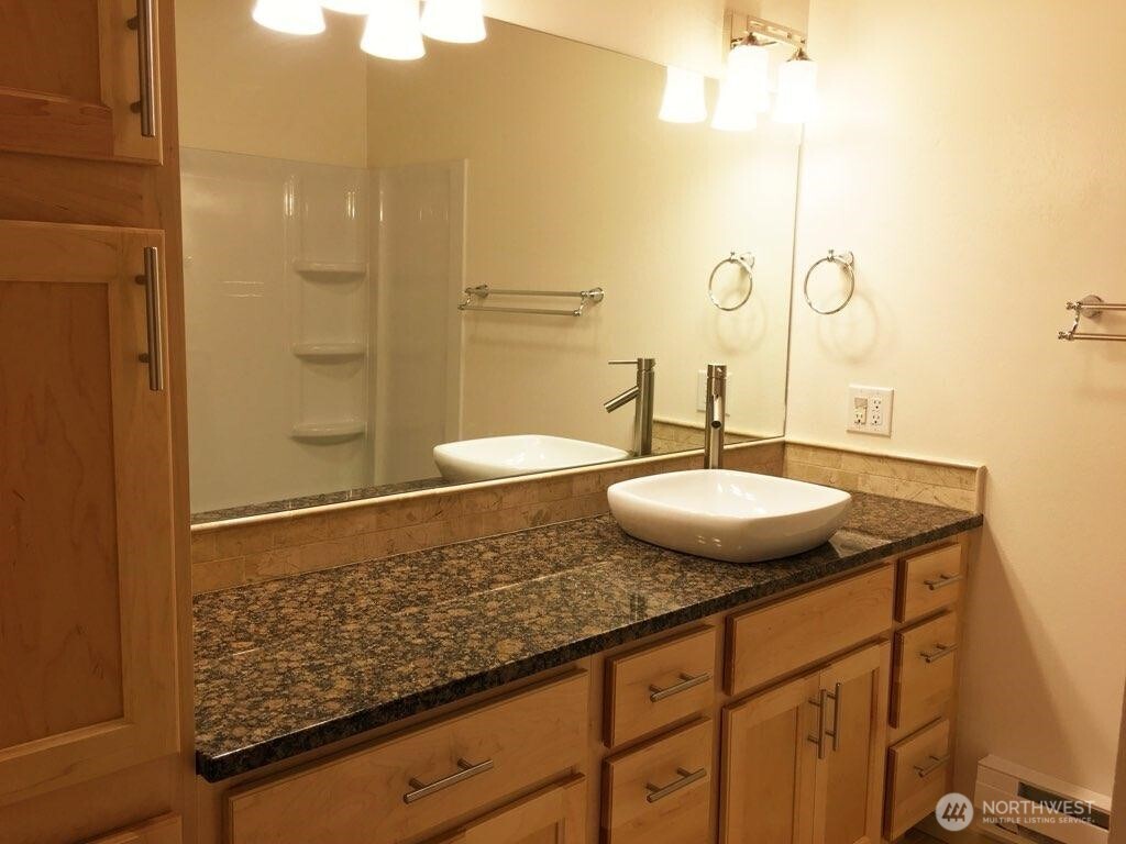 8417 Gold Way Everett, WA 98208 - Photo 7 of 18 a bathroom with a granite countertop sink a mirror and shower