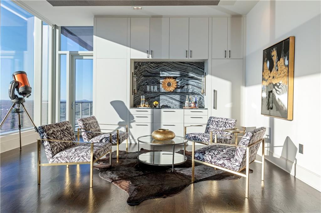 3630 Peachtree Road Northeast, Unit 3401 Atlanta, GA 30326 - Photo 16 of 72 a living room with furniture a wooden floor and a fireplace