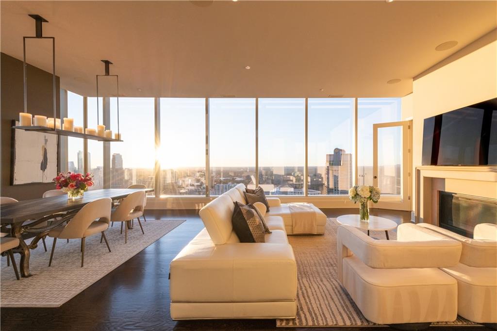 3630 Peachtree Road Northeast, Unit 3401 Atlanta, GA 30326 - Photo 42 of 72 a living room with furniture a fireplace and city view