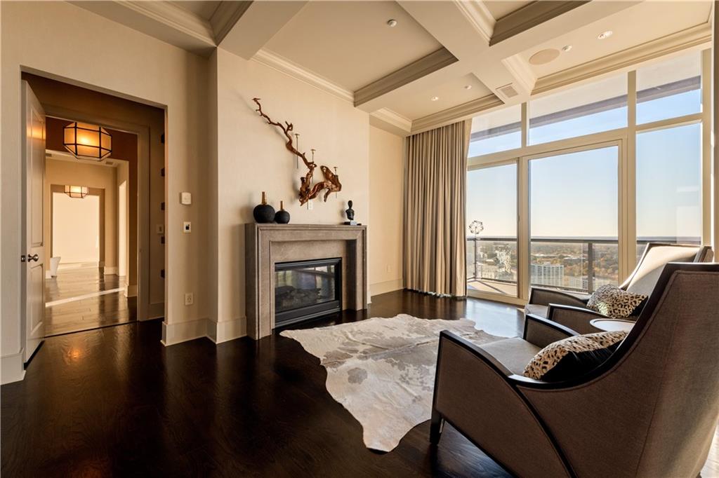 3630 Peachtree Road Northeast, Unit 3401 Atlanta, GA 30326 - Photo 47 of 72 a living room with furniture and a fireplace