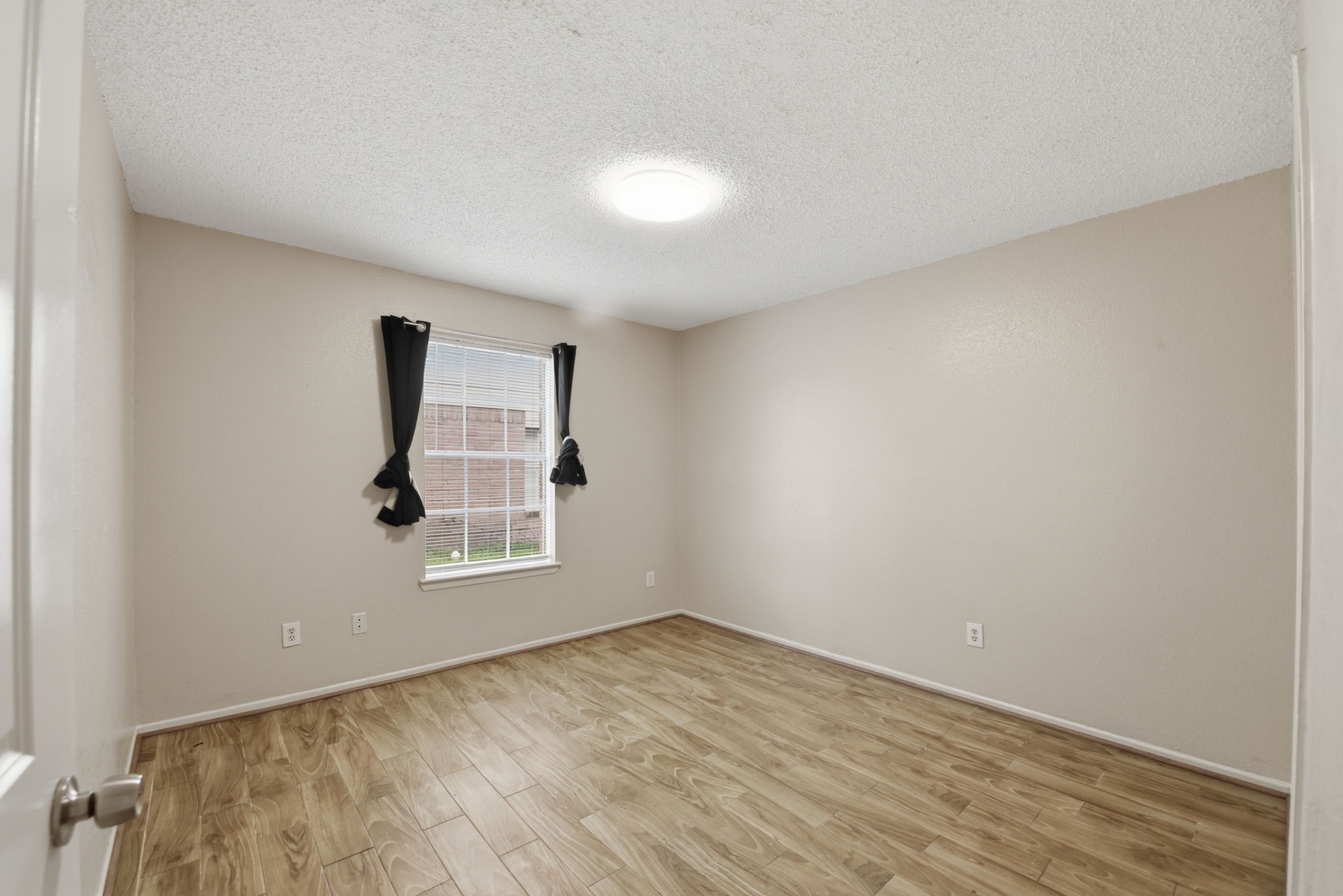 1310 Brenda Lane, Unit A Humble, TX 77338 - Photo 11 of 16 an empty room with a window