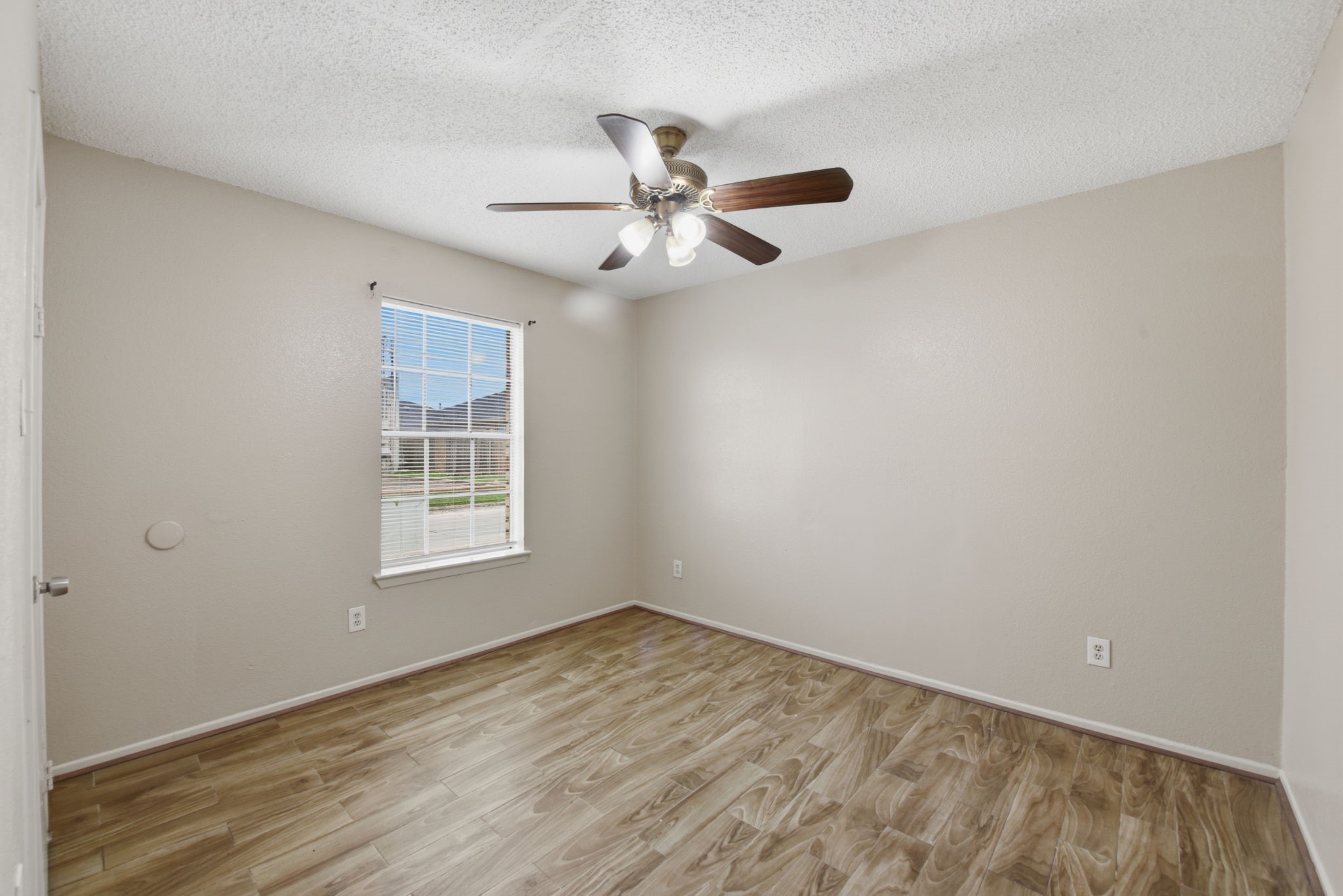 1310 Brenda Lane, Unit A Humble, TX 77338 - Photo 13 of 16 an empty room with a window and ceiling fan