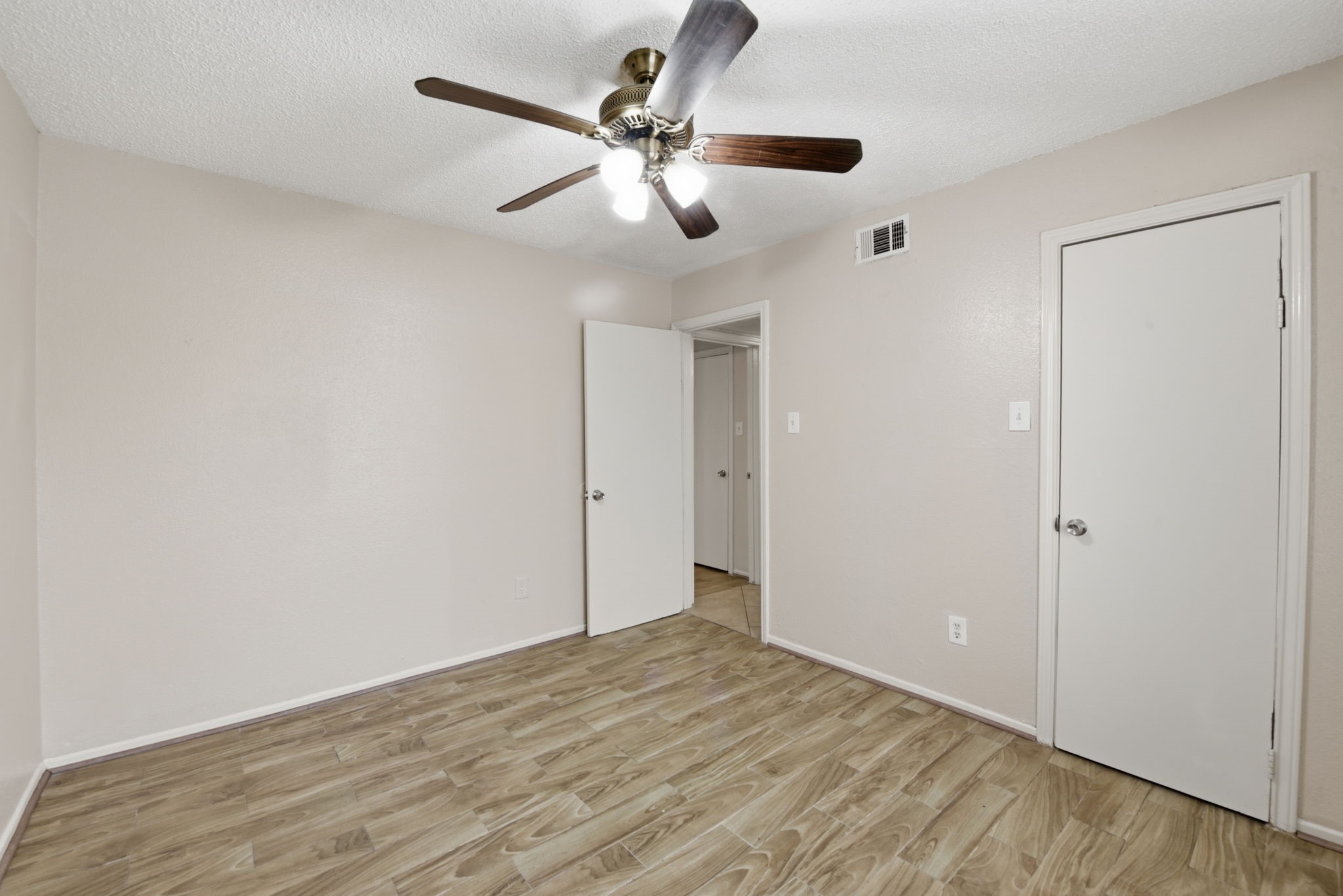 1310 Brenda Lane, Unit A Humble, TX 77338 - Photo 14 of 16 wooden floor in an empty room