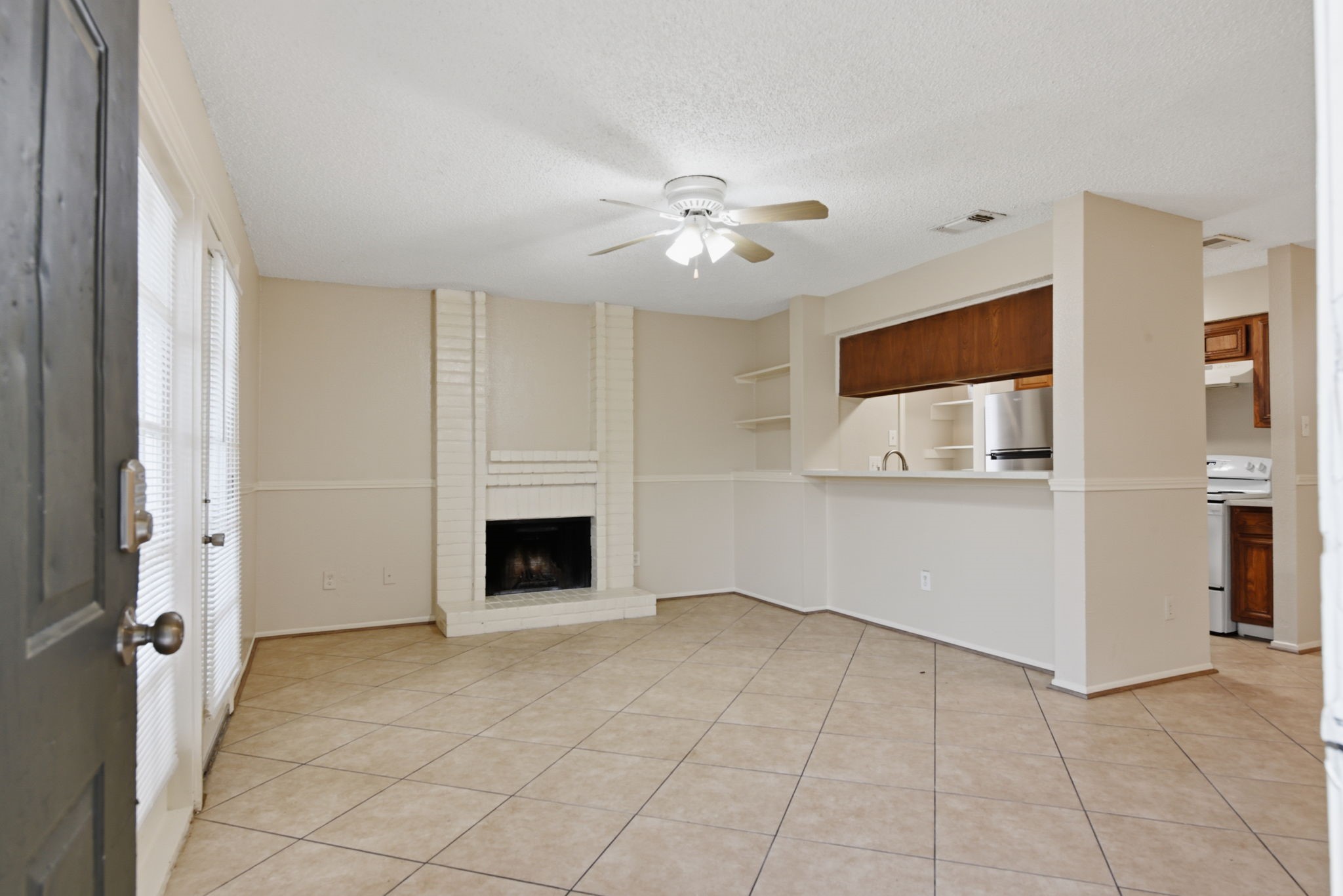 1310 Brenda Lane, Unit A Humble, TX 77338 - Photo 6 of 16 a view of a livingroom with an empty space and a kitchen