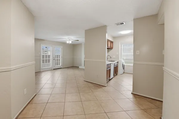 a view of a kitchen with furniture and an empty room