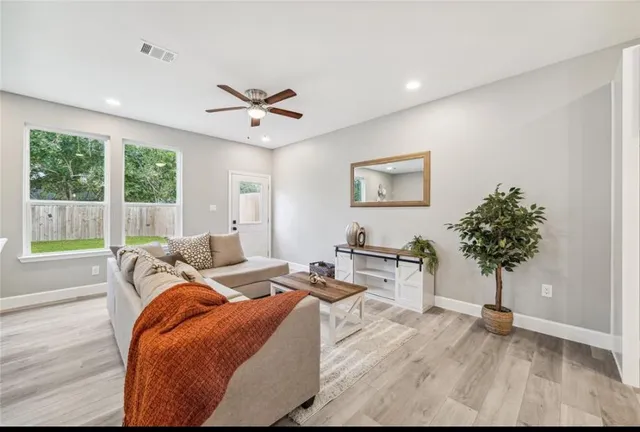 a bedroom with furniture and a large window