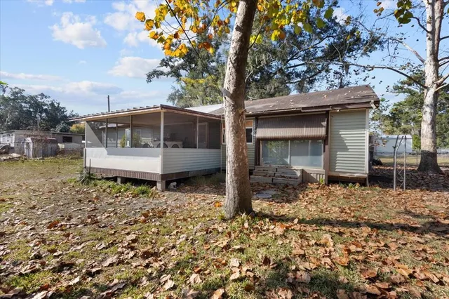 a backyard of a house with table and chairs