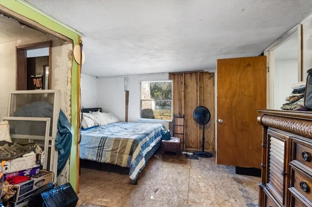 a bedroom with a bed and a window