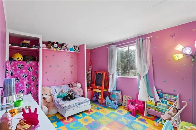 a bedroom with bed and a window