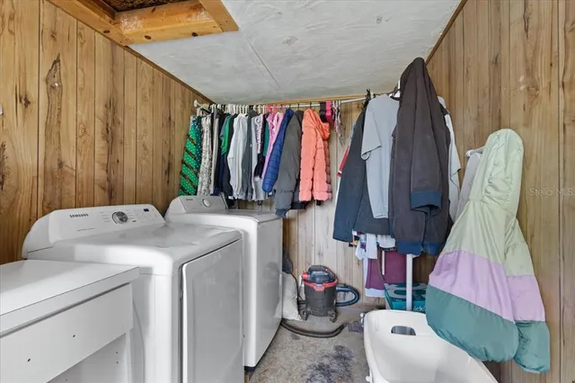 a kitchen with stainless steel appliances granite countertop a stove and a bookshelf