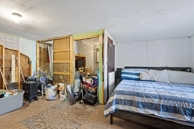 a bedroom with furniture and a large window