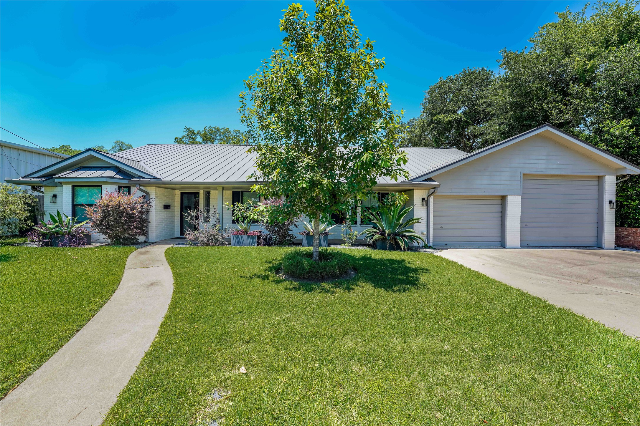 1124 Bowie Street Columbus, TX 78934 - Photo 1 of 28 a front view of a house with a yard
