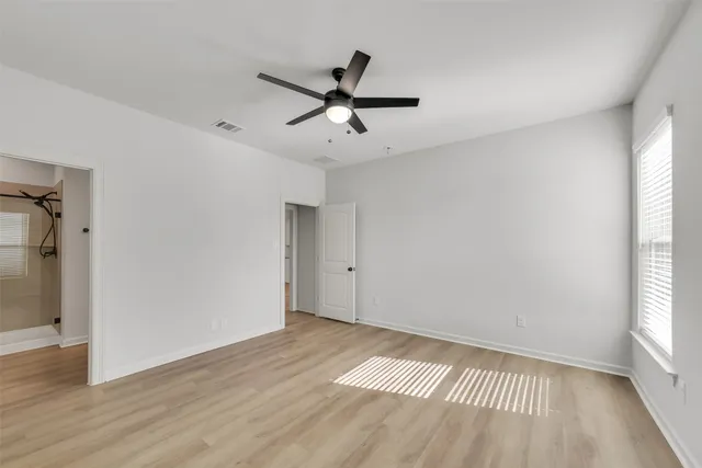 a view of a room with wooden floor and windows