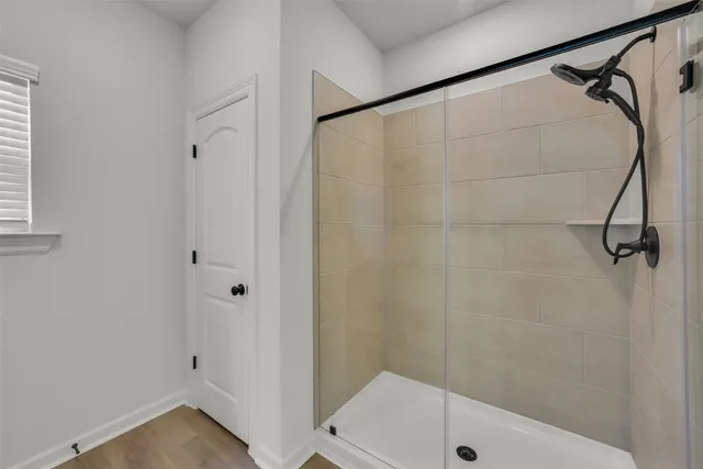 a bathroom with a shower and a window