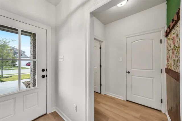 a view of an entryway with wooden floor