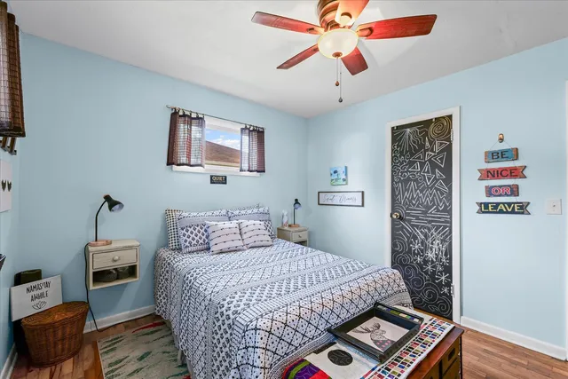 a bedroom with a bed and a book shelf